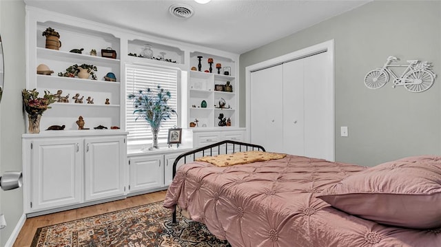 bedroom featuring light wood-type flooring and a closet