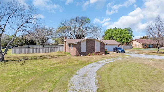 view of front of property with a front yard and a garage