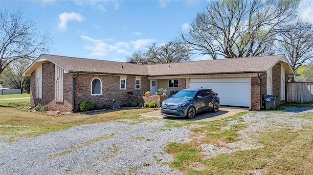 single story home featuring a front lawn and a garage