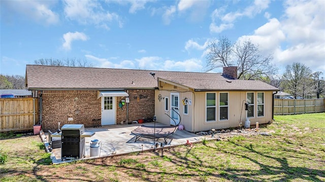 back of house featuring a yard and a patio