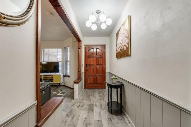 entryway featuring a chandelier and light hardwood / wood-style flooring