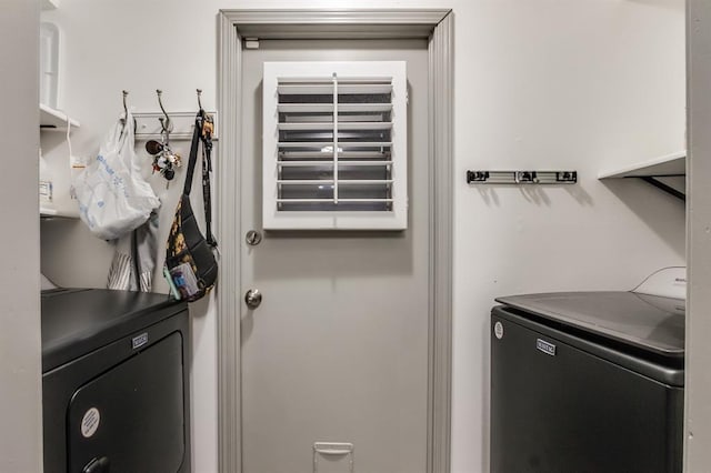 clothes washing area with washer and dryer