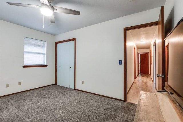 carpeted spare room featuring ceiling fan