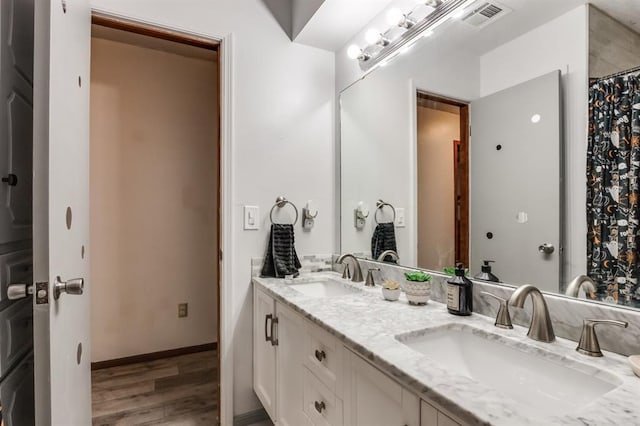 bathroom featuring hardwood / wood-style flooring and vanity