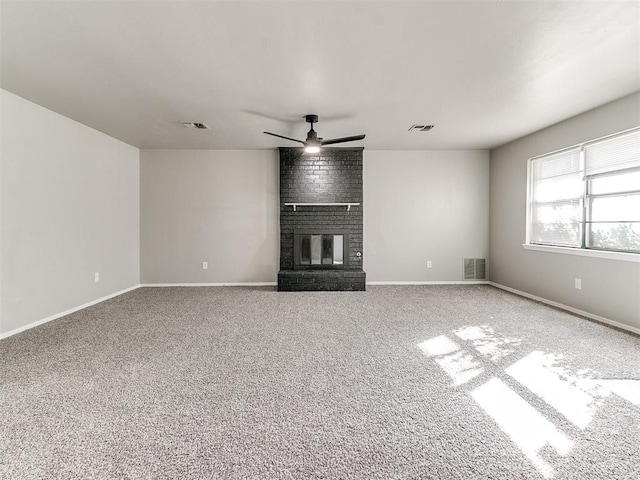 unfurnished living room featuring carpet, ceiling fan, and a fireplace