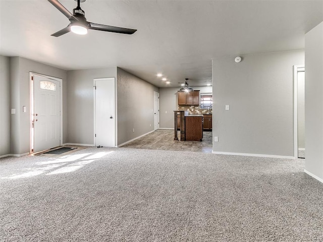 unfurnished living room with light carpet and ceiling fan