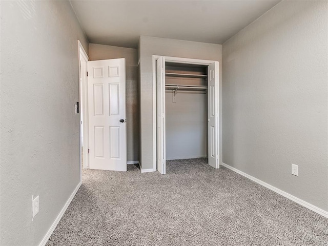 unfurnished bedroom with carpet and a closet