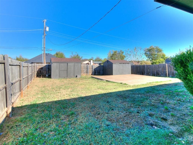 view of yard featuring a patio and a shed