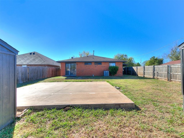 rear view of house with a lawn and a patio area