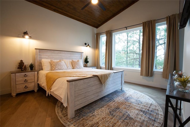 bedroom with ceiling fan, dark hardwood / wood-style flooring, wooden ceiling, and vaulted ceiling