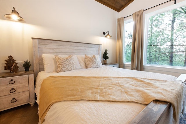 bedroom featuring dark hardwood / wood-style flooring and lofted ceiling