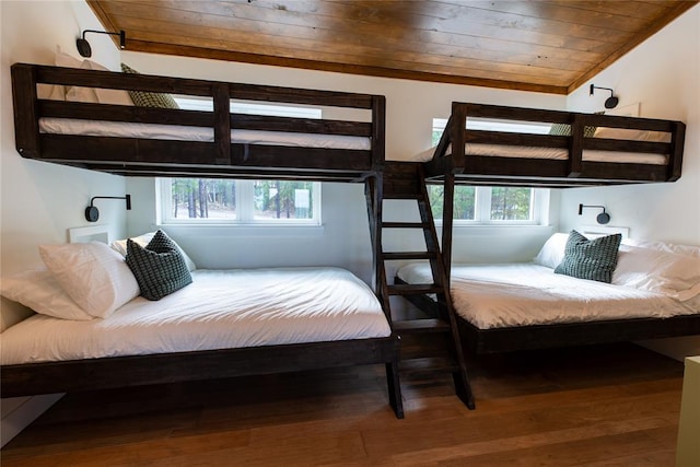 bedroom featuring hardwood / wood-style floors and wood ceiling