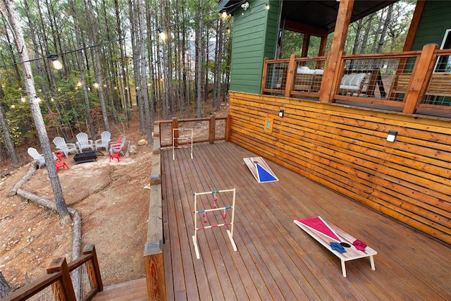 wooden terrace with an outdoor fire pit