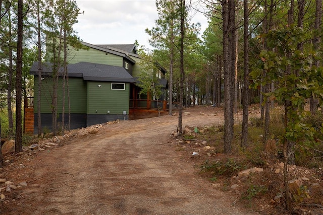 view of property exterior with a wooden deck