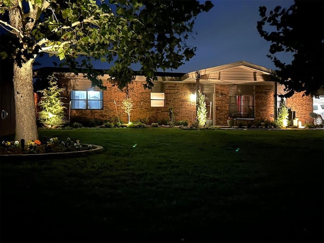 ranch-style home featuring a lawn