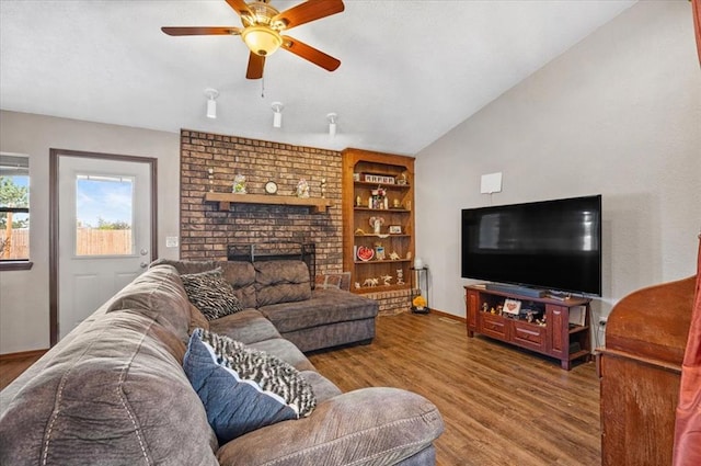 living room with ceiling fan, a fireplace, wood-type flooring, and vaulted ceiling