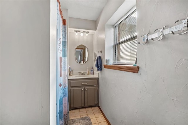 bathroom with tile patterned floors and vanity