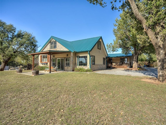 back of property with a yard and a patio area