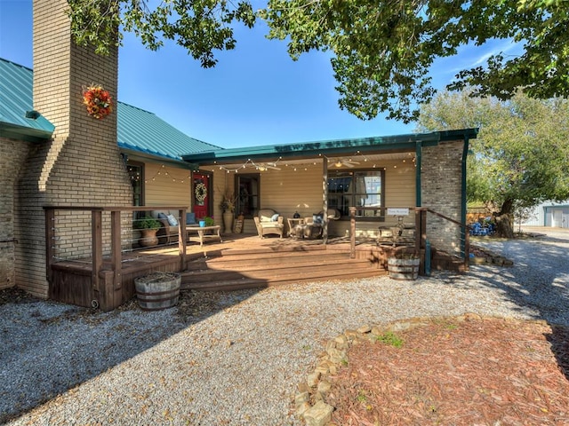 back of property featuring a wooden deck