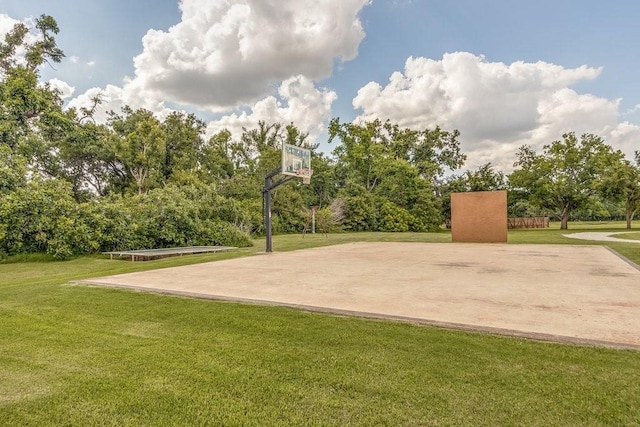 view of sport court with a yard