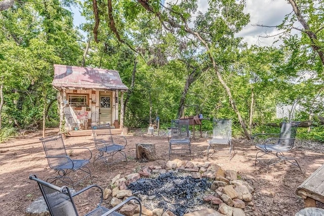 view of patio with an outbuilding and an outdoor fire pit