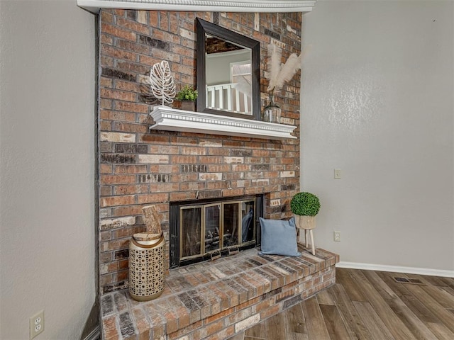 interior details with a fireplace and hardwood / wood-style floors