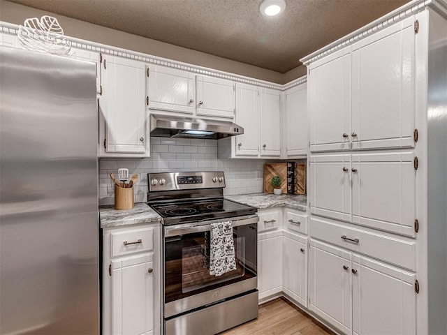 kitchen with decorative backsplash, appliances with stainless steel finishes, light hardwood / wood-style floors, light stone counters, and white cabinetry