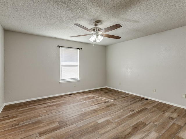 unfurnished room featuring ceiling fan, light hardwood / wood-style flooring, and a textured ceiling