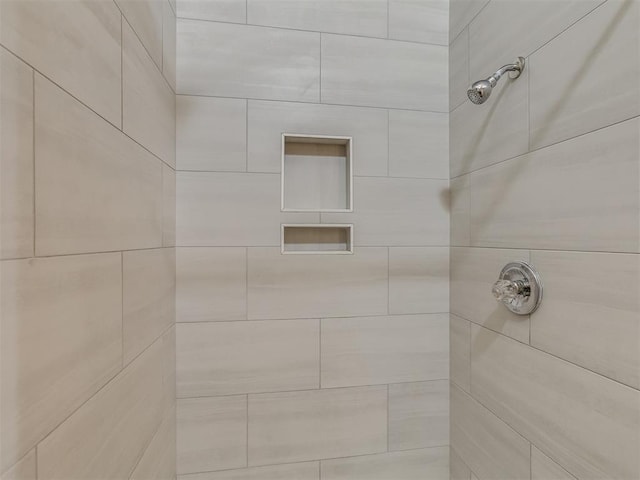 bathroom with tiled shower