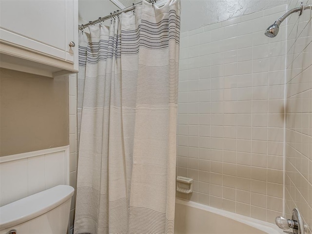 bathroom with shower / bath combo and toilet