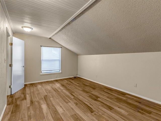 bonus room with light hardwood / wood-style flooring and vaulted ceiling