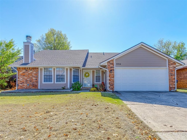 ranch-style home with a front yard and a garage