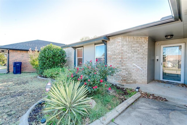 doorway to property with a lawn