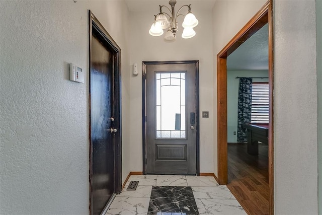 foyer with a notable chandelier and light wood-type flooring