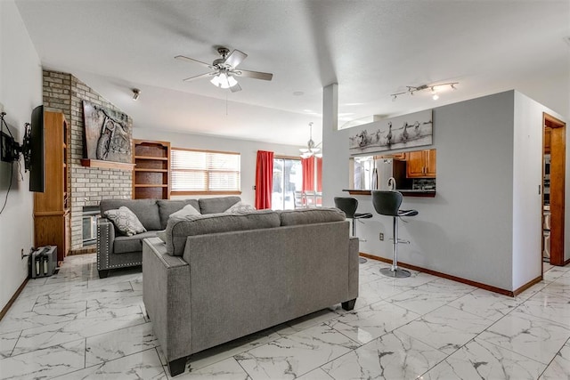 living room with ceiling fan with notable chandelier