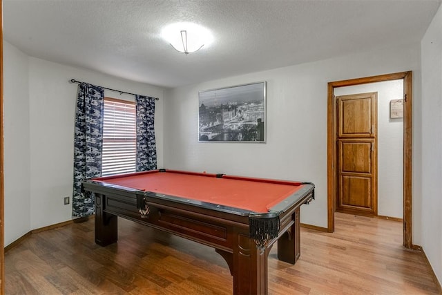 rec room featuring a textured ceiling, light wood-type flooring, and pool table