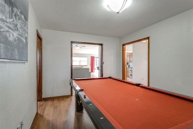 recreation room featuring a textured ceiling, hardwood / wood-style flooring, and pool table