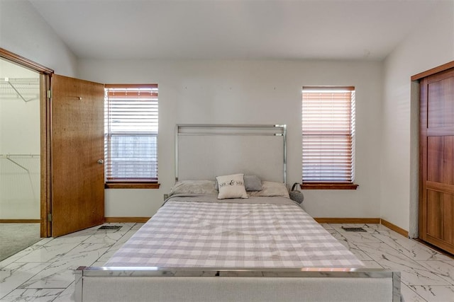 bedroom featuring a walk in closet and a closet