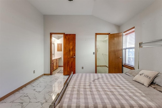 bedroom with connected bathroom, a spacious closet, a closet, and vaulted ceiling