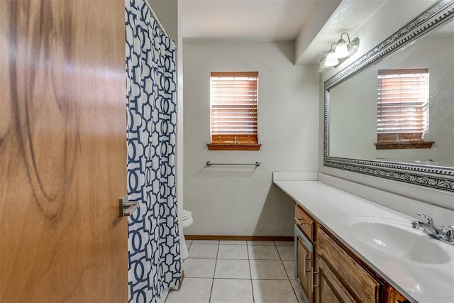 bathroom with tile patterned floors, vanity, and toilet