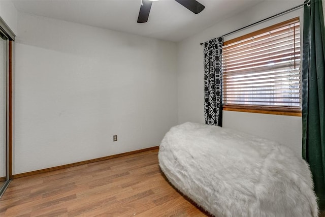 bedroom with light hardwood / wood-style flooring and ceiling fan