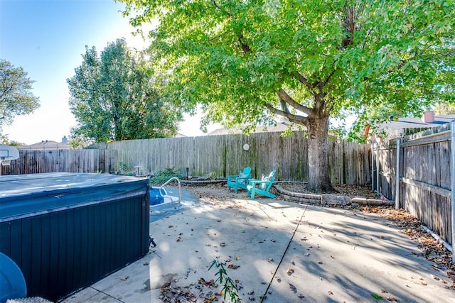 view of patio / terrace with a hot tub