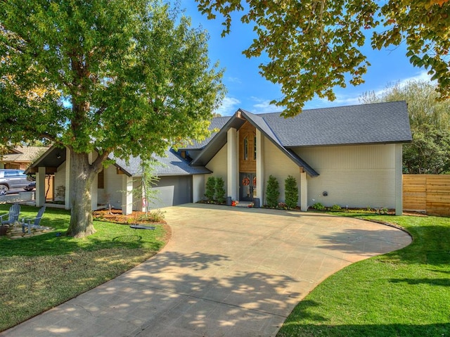 view of front facade with a garage and a front lawn