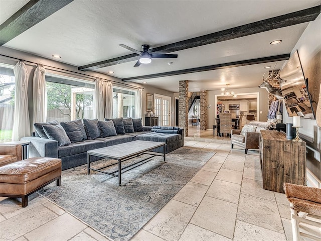 living room with beam ceiling and ceiling fan with notable chandelier