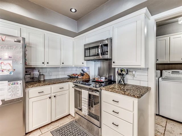 kitchen with backsplash, dark stone countertops, white cabinetry, and stainless steel appliances