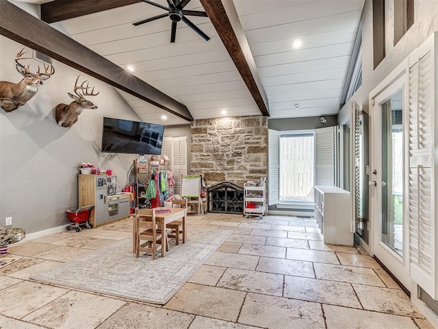 living room featuring vaulted ceiling with beams, ceiling fan, and a fireplace