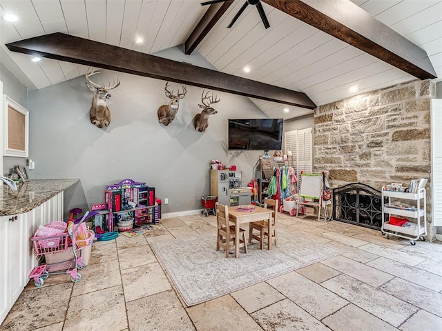 rec room with vaulted ceiling with beams