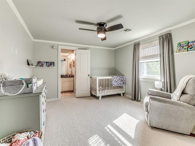 bedroom with a crib, light carpet, ceiling fan, and crown molding