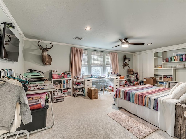 carpeted bedroom featuring a textured ceiling, ceiling fan, and ornamental molding