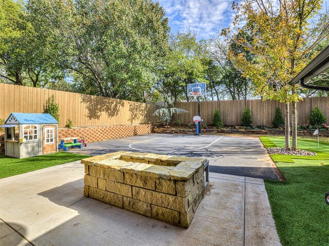 view of patio / terrace featuring an outbuilding and basketball court